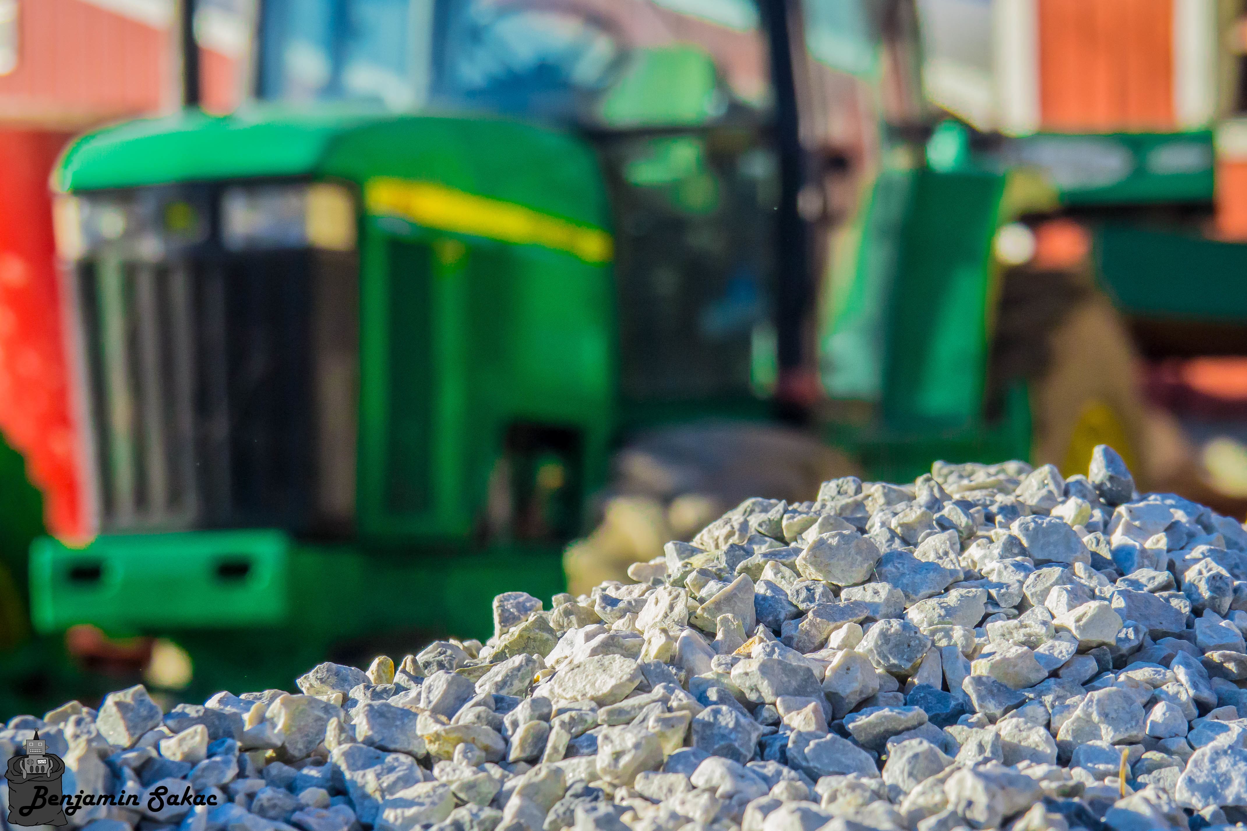 Pile of white stone with tractor in background